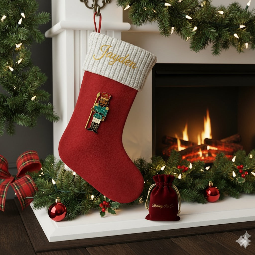 Heritage Pin Co. Nutcracker pin clipped to a holiday stocking by the fireplace — the perfect touch for a meaningful stocking stuffer.